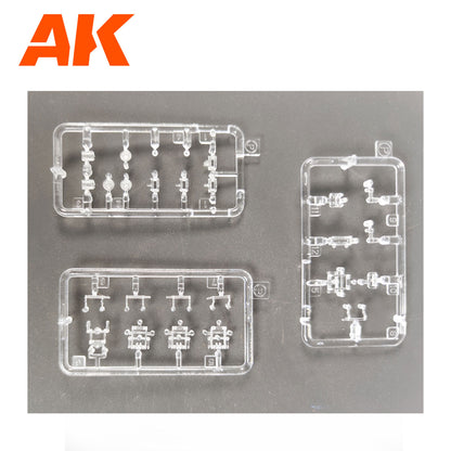 Three clear plastic model kit sprues with intricate parts are on a dark background