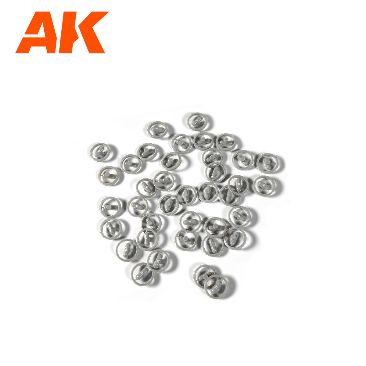 Scattered gray miniature soda can tops on a white background