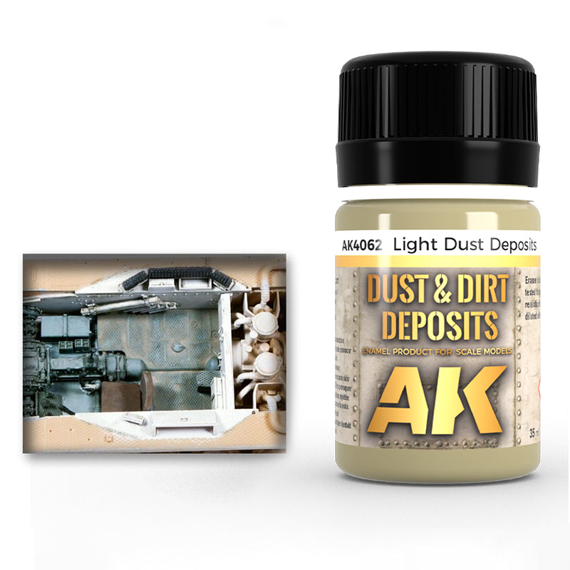 Bottle of AK Interactive 'Light Dust Deposits' weathering paint next to a dusty scale model tank interior