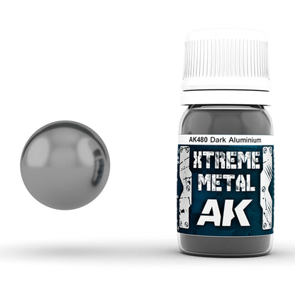 A bottle of AK Xtreme Metal Dark Aluminium paint beside a reflective dark grey metallic sphere