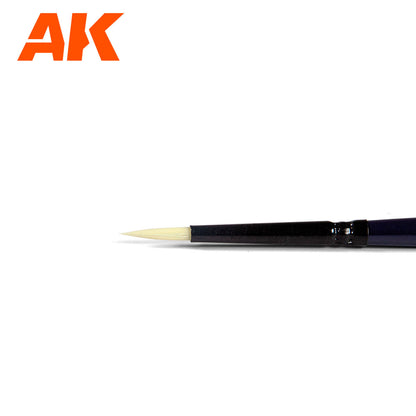 Orange AK logo above a pointed paint brush with light cream bristles and a dark handle