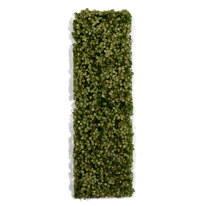 A rectangular panel densely covered in small green artificial leaves, casting a shadow on a white background