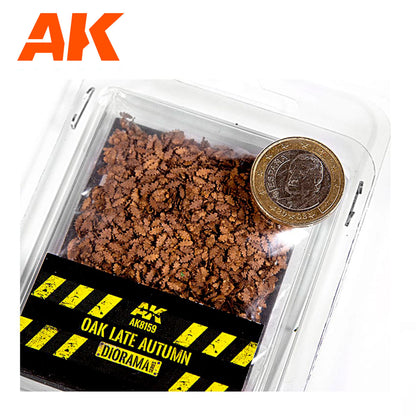 AK miniature brown oak leaves diorama material in a clear package, with a 1 Euro coin for scale