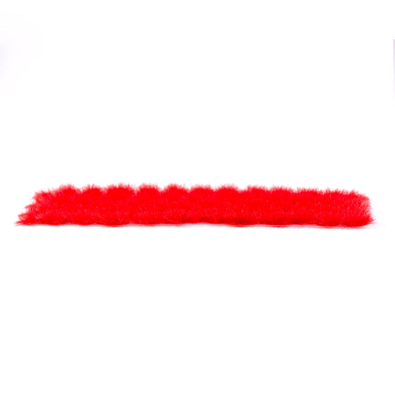 A horizontal strip of vivid red fluffy AK Interactive 4mm wargame vegetation tufts is shown against a plain white background