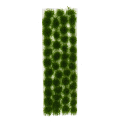 A clear rectangular sheet holds many uniformly arranged dark green grass tufts, each approximately 4mm in height
