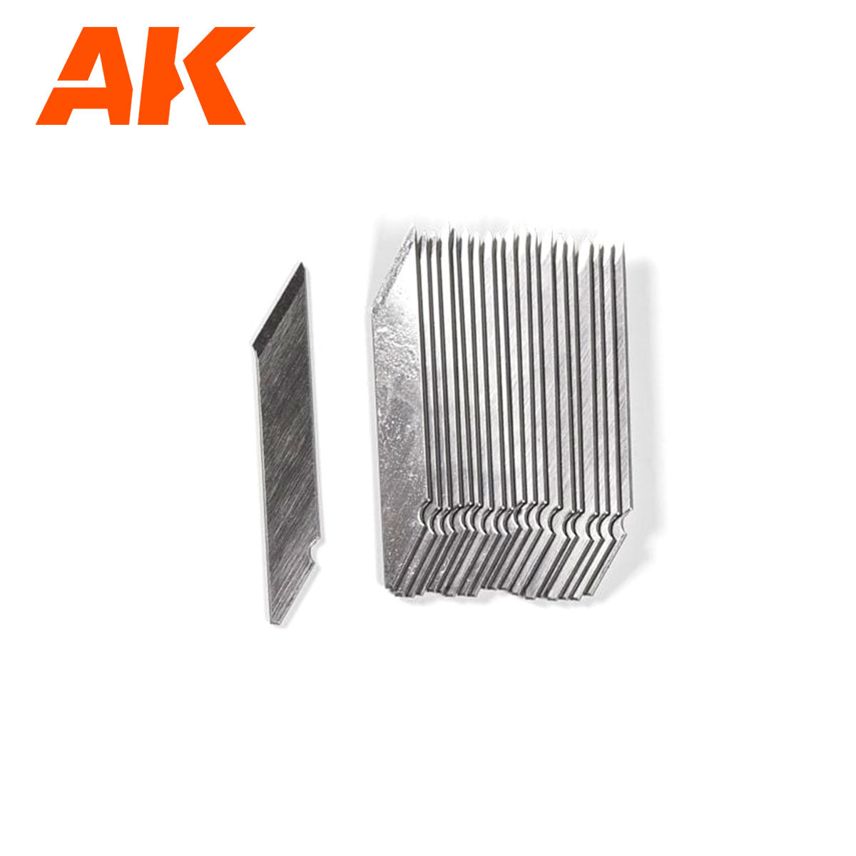 A single silver hobby knife blade next to a stack of identical blades on a white background