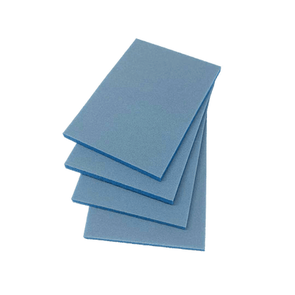 Four rectangular blue 400 Grit Fine Sanding Pads are stacked diagonally on a dark green background