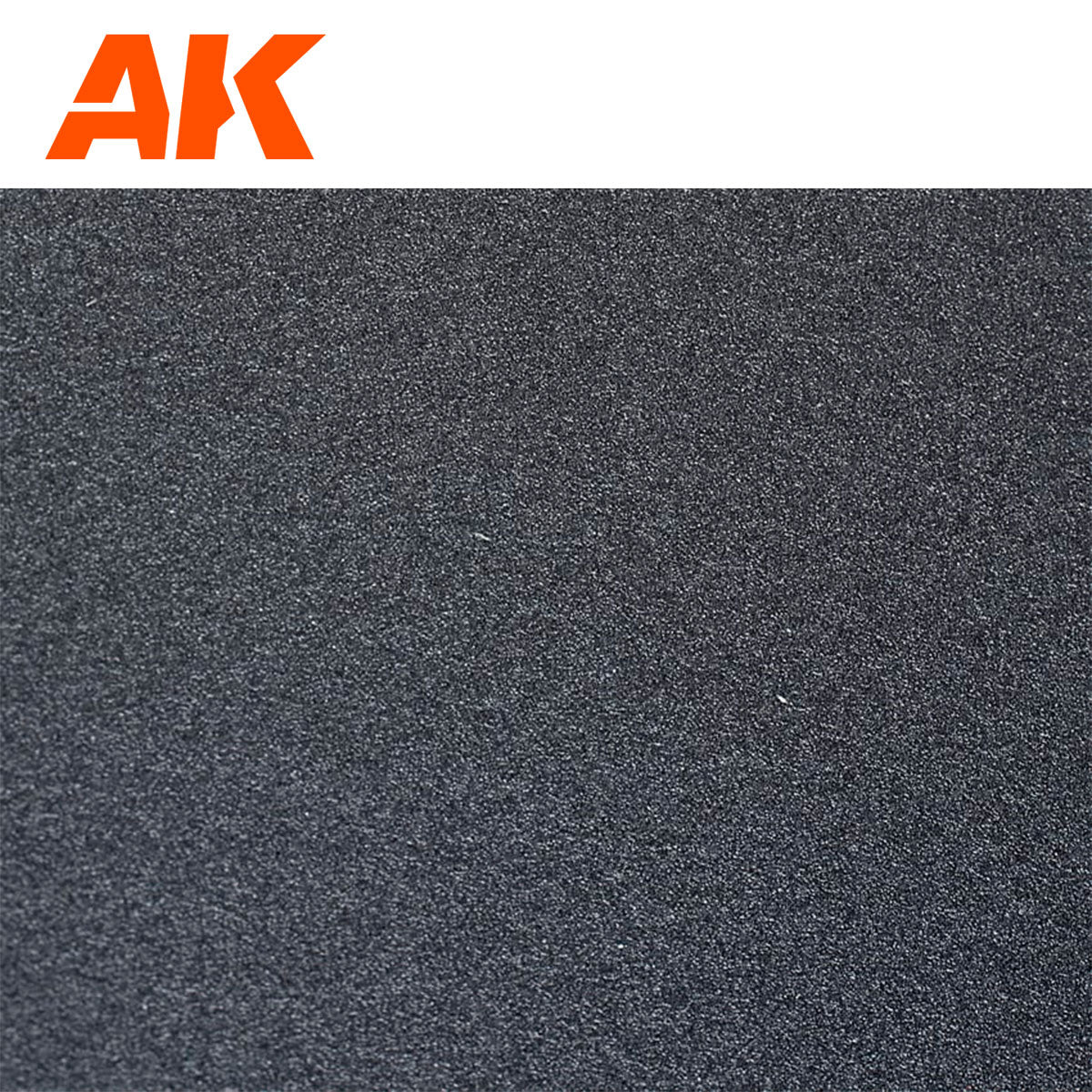 Close-up of a coarse, dark gray textured surface sandpaper with an orange "AK Interactive " logo in the top left