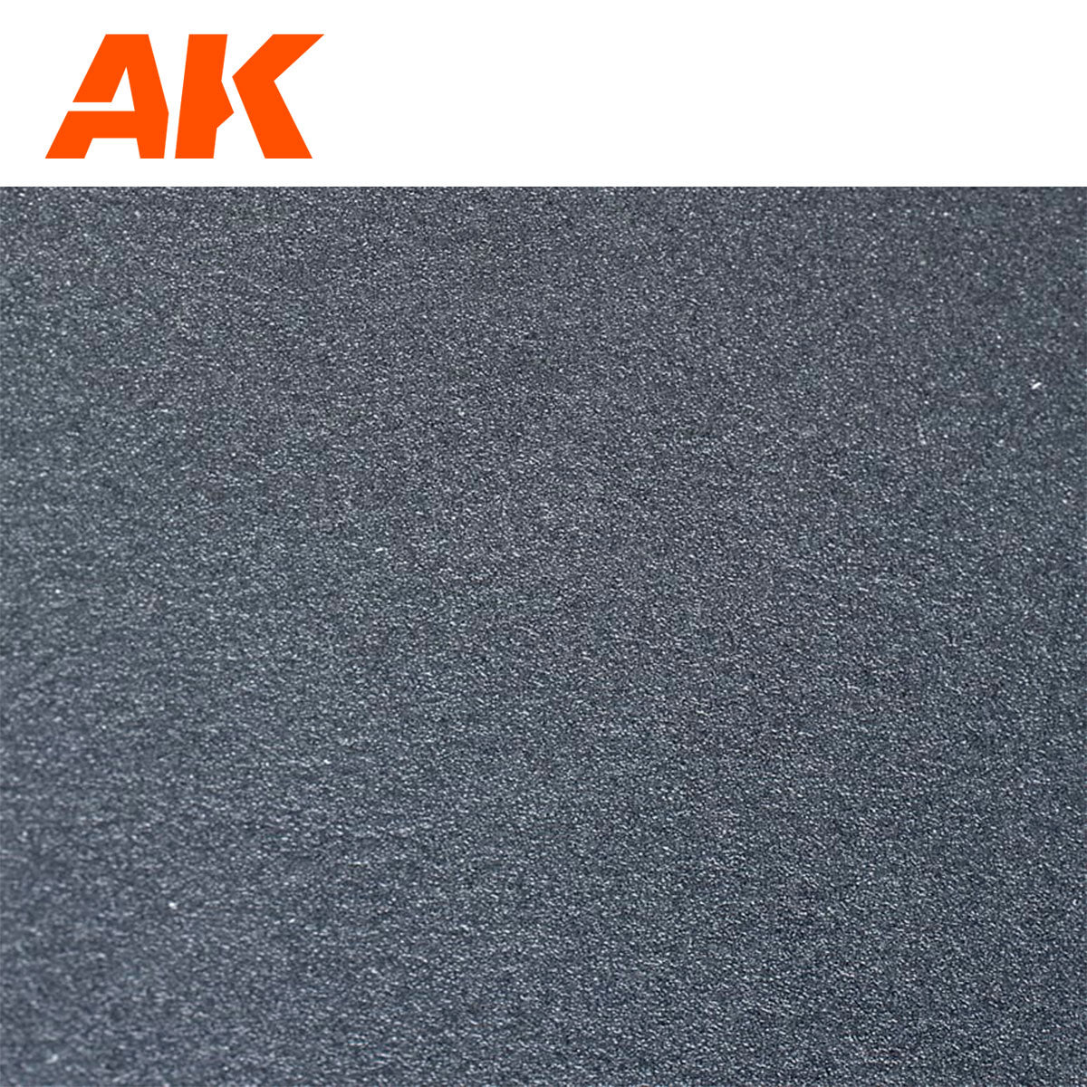 Close-up of orange AK Interactive logo and dark gray sandpaper texture