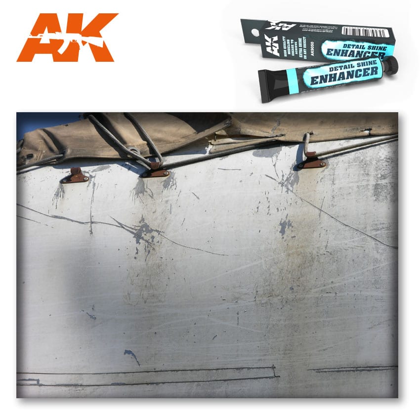 AK Detail Shine Enhancer tube & box above a close-up of a heavily scratched, dirty white vehicle panel with canvas top.