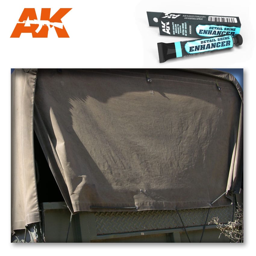 AK Detail Shine Enhancer product and box next to a weathered, drab canvas tarp. Used for realistic model weathering effects.