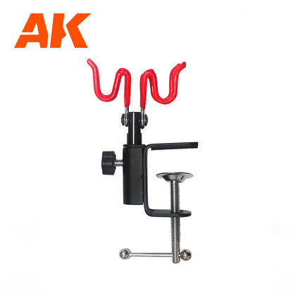 AK airbrush holder with two red wavy rests and a black desk clamp