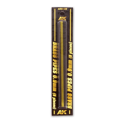 AK BRASS PIPES 0.9mm (5 pieces) in a clear blister pack on a dark card with gold lettering.