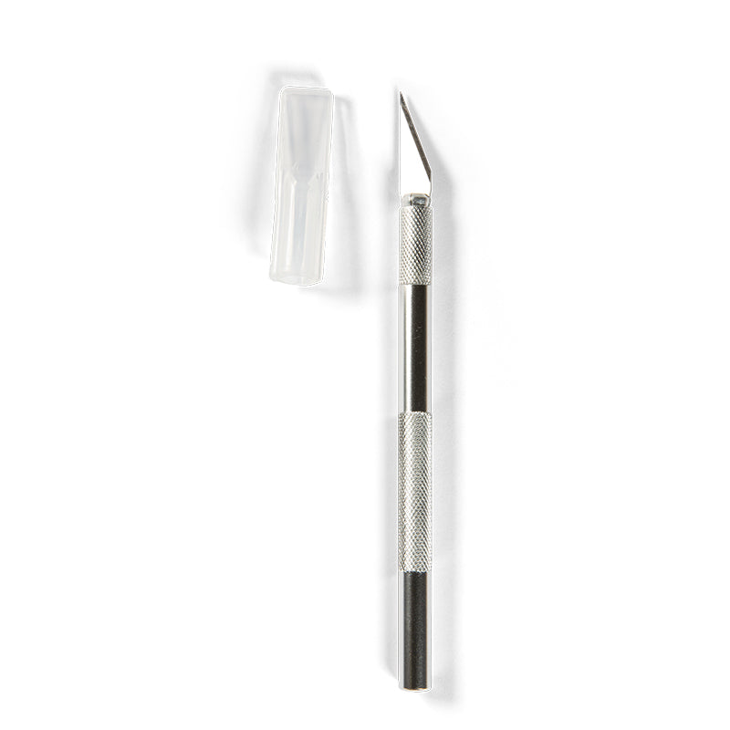 Silver craft knife with an exposed blade and its clear safety cap removed, against a white background