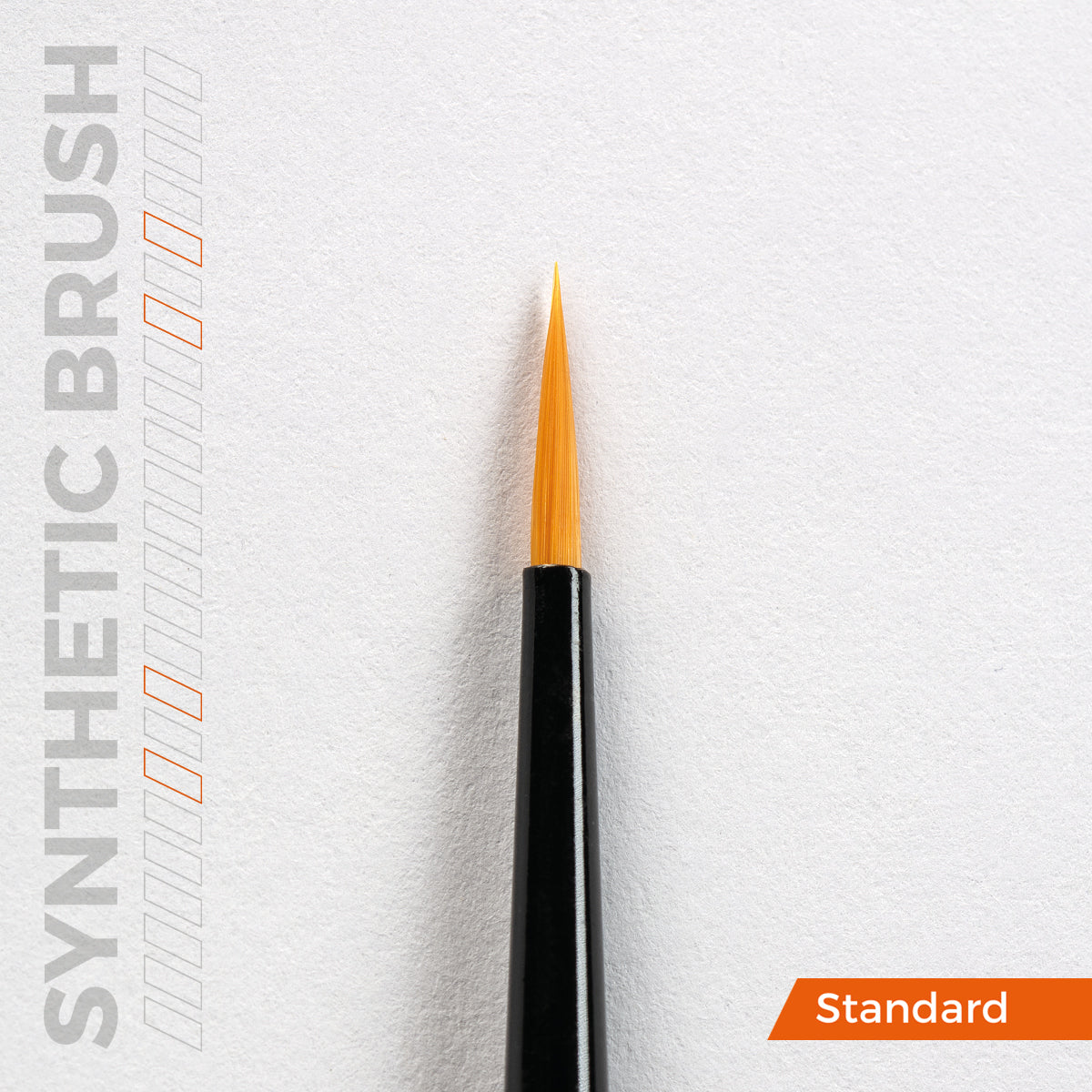 A close-up of a precision brush with a black handle and pointed orange synthetic bristles against a white textured background, with SYNTHETIC BRUSH and Standard text