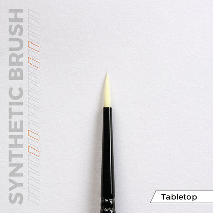 A synthetic brush with a black handle and light, pointed bristles stands on a textured white background