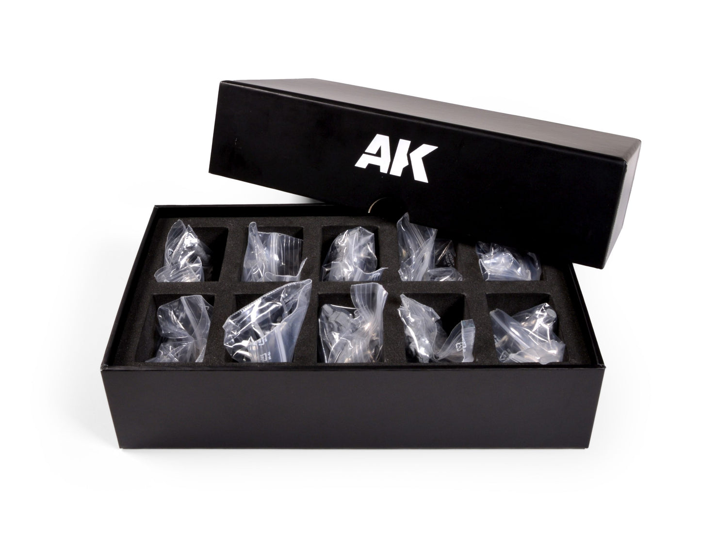 Open black box with AK logo containing small, bagged items in a foam insert