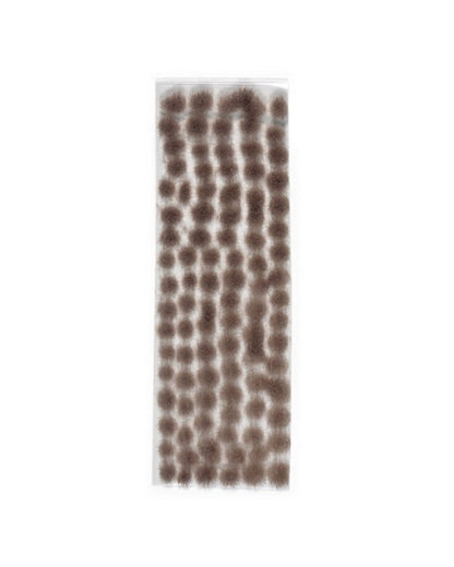 Brown-grey static grass tufts arranged on a clear sheet for model scenery