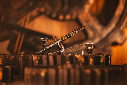 Detailed airbrush and accessories displayed on a dark, rust-colored industrial background