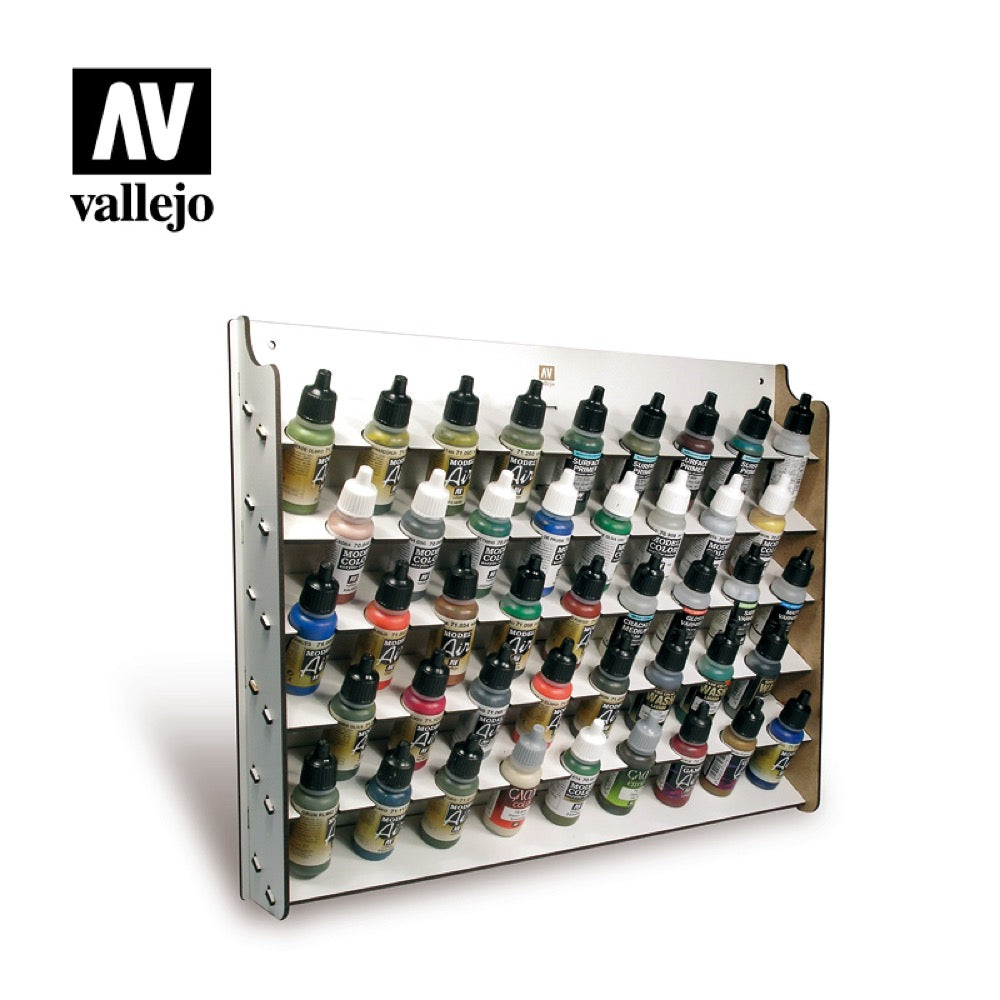 White wooden rack organized with dozens of colorful Vallejo model paint bottles