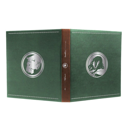 A green book with a brown spine, featuring silver circular emblems of a lion's head and a flowing-haired profile
