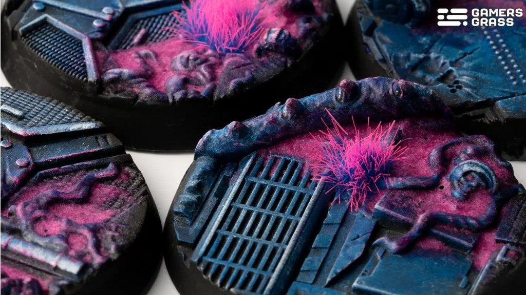 Miniature wargaming bases featuring dark sci-fi terrain with grates and vivid neon pink plant tufts.