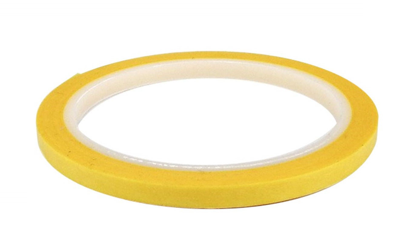A roll of narrow yellow tape with a white core on a white background.