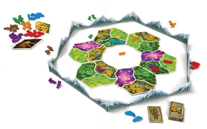 A "Dino Party" board game setup. Hexagonal terrain tiles with colorful dinosaurs are surrounded by mountain walls. Piles of dino tokens and cards.