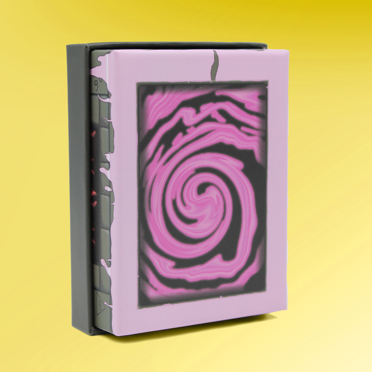 A standing purple box with a vibrant pink and black swirling vortex design on its cover, the dark grey spine appears cracked, yellow background