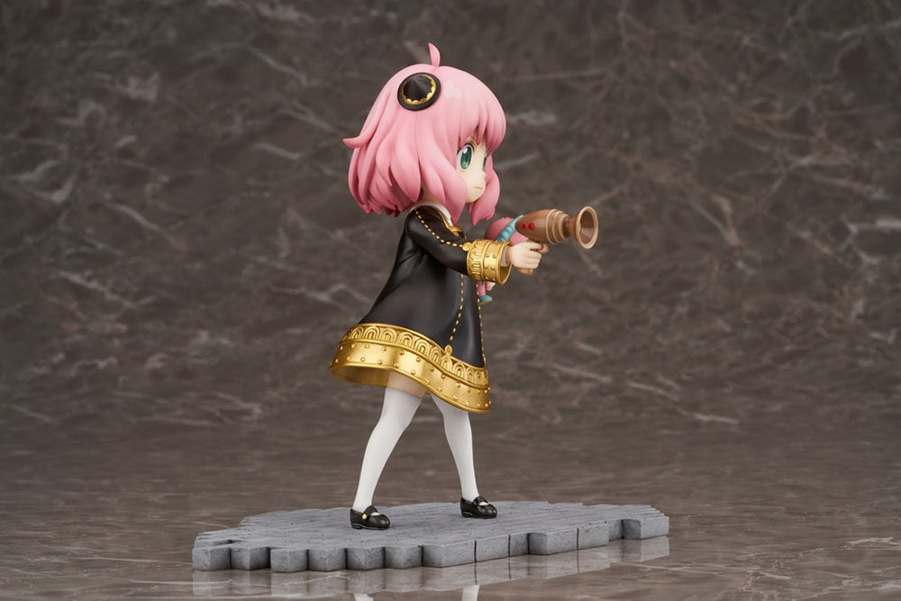 Side view of Anya Forger figure in a black dress, holding a megaphone and a pink Chimera plush
