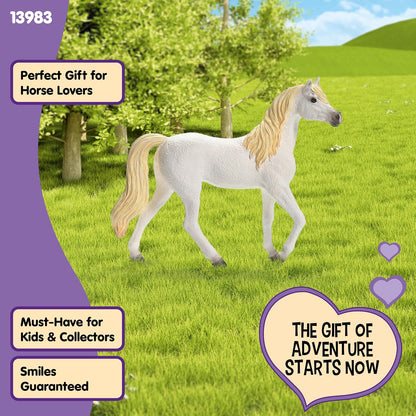 A white horse figurine with flowing blonde mane and tail stands in a bright green field under a blue sky