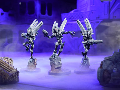 Three armored dark sci-fi miniatures with glowing red eyes and weapons, posed dynamically in a smoky, purple-lit setting