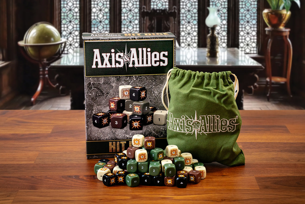 Axis &amp; Allies game box, green bag, and multi-colored &quot;hit&quot; dice displayed on a wooden table