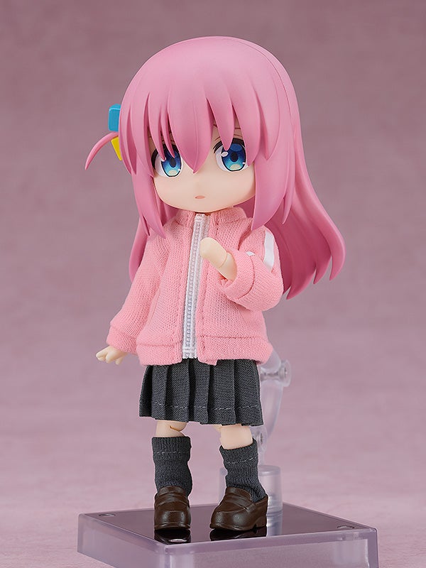 Nendoroid of Bocchi the Rock&#39;s Hitori Gotou in a pink jacket gray skirt and dark gray socks on color background