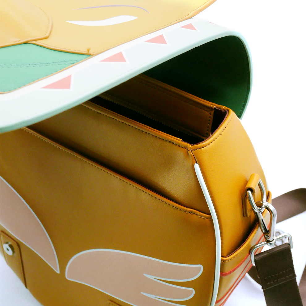 Open yellow bag with green-trimmed flap, pink triangles, and a peach wing design, showing its interior pockets.