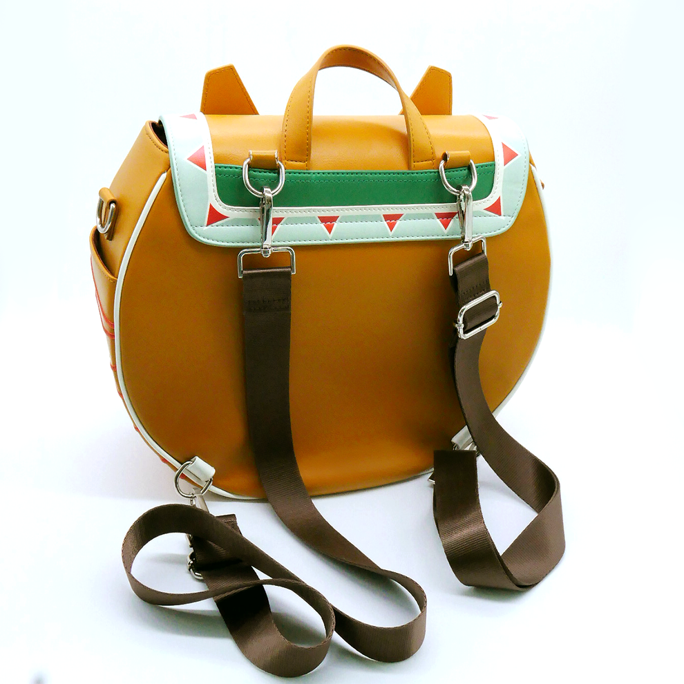 A golden-brown rounded backpack with a mint green flap, red & white triangles, and brown shoulder straps.
