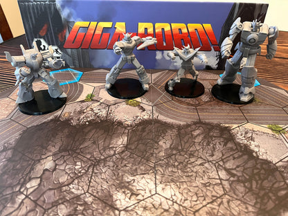 Grey robot miniatures from the GIGA-ROBO! board game stand on a cracked city map