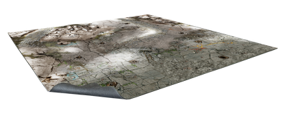 Angled battle mat showing a ruined city with cracked pavement, cobblestones, and dirt. A corner is curled up.