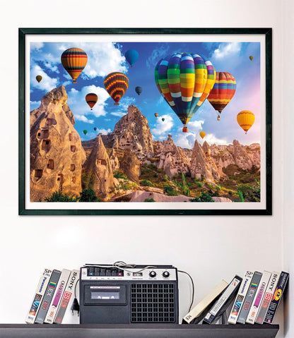 A framed picture shows colorful hot air balloons flying over unique rocky landscapes and ancient cave dwellings.