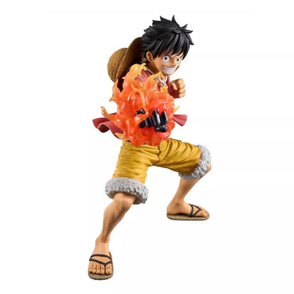 Anime figure of Luffy (One Piece) mid-stride, wearing yellow shorts and engulfed in bright orange flames