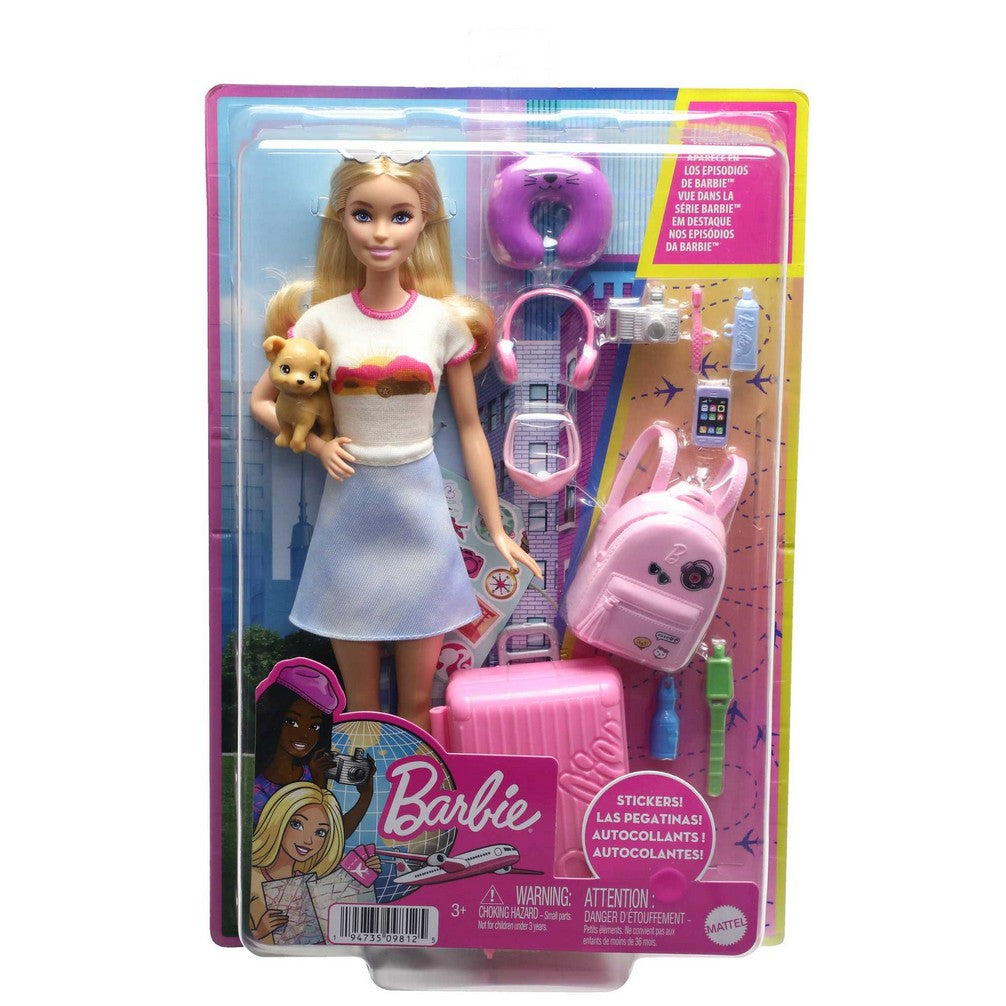 Packaged Barbie travel doll: blonde, white top, blue skirt, holding a puppy. Includes pink backpack and suitcase