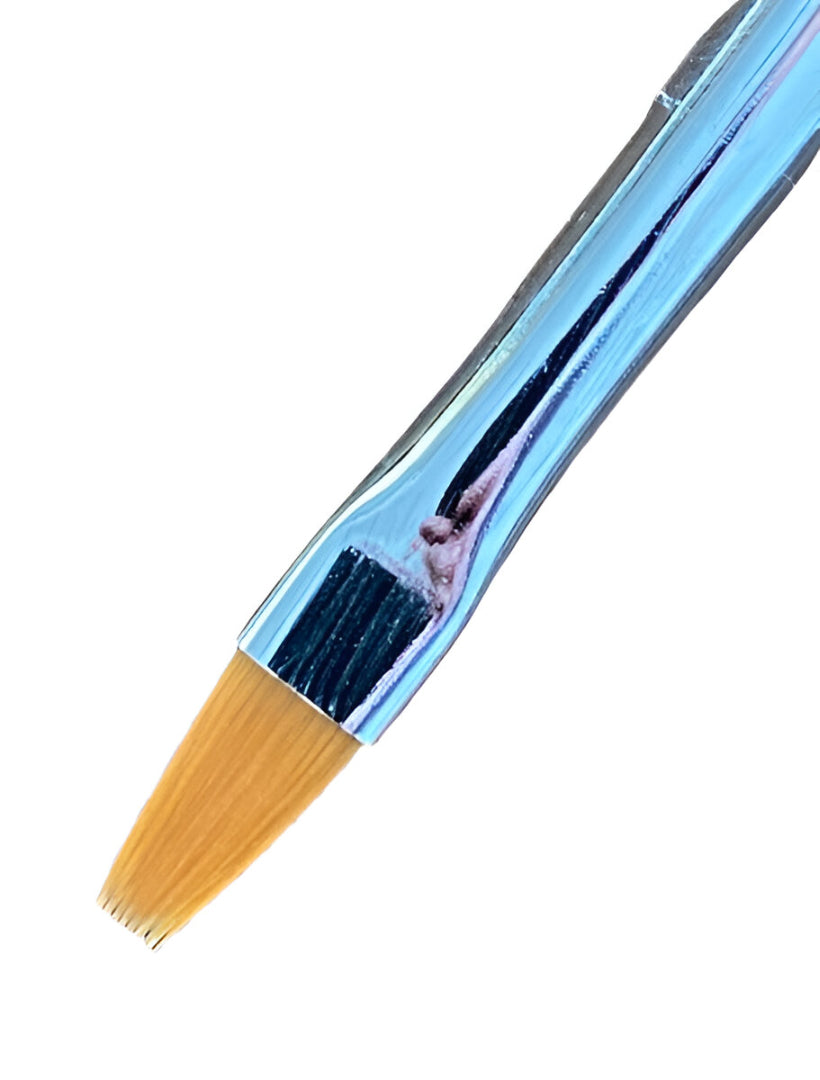Flat Toray paint brush with golden bristles and a silver ferrule against a white background