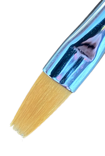 Close-up of a flat Toray paint brush with splayed light brown bristles and a shiny blue ferrule