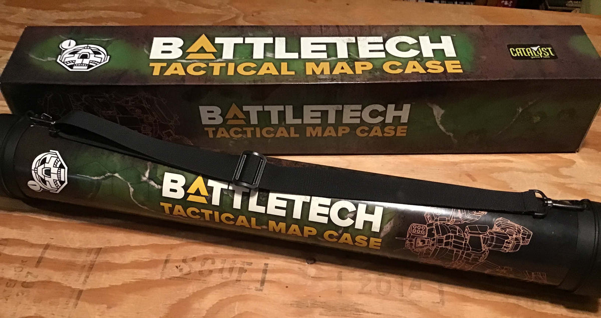 A cylindrical BattleTech Tactical Map Case, dark green with mech artwork and a strap, rests in front of its matching product box