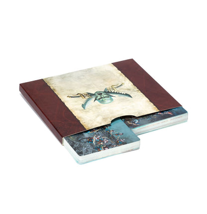 Dark red card sleeve with a stylized winged face on parchment, showing fantasy art cards partially pulled out