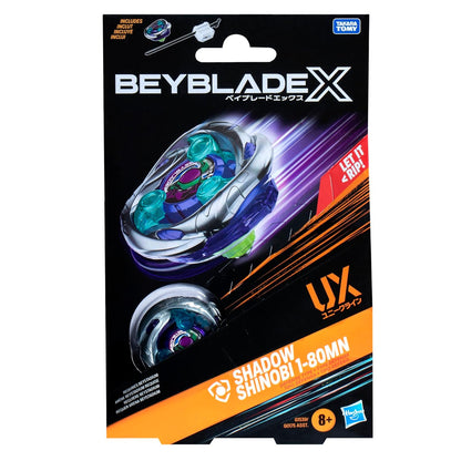 Beyblade X Shadow Shinobi toy packaging featuring a blue, green and silver spinning top with energy trails and a launcher