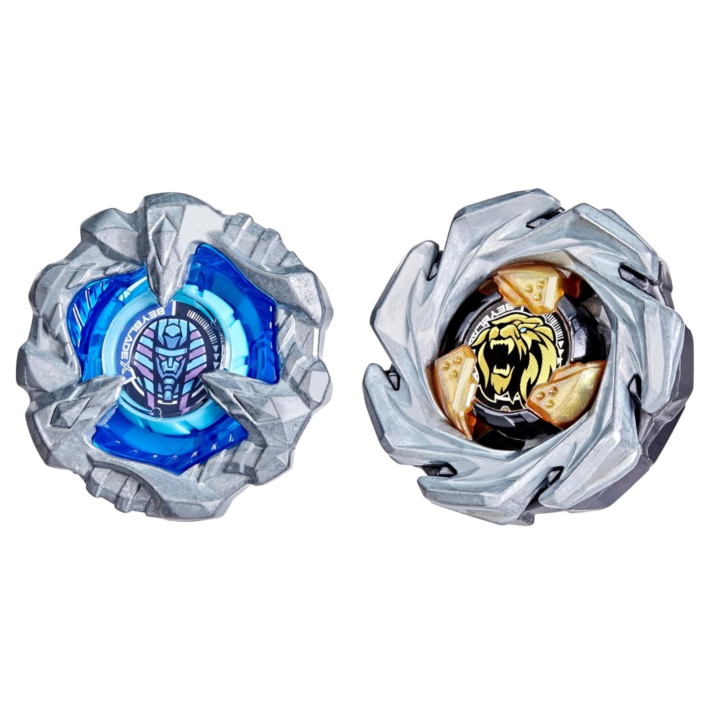 Two Beyblade spinning tops with metallic gray shells. One has a blue pharaoh, the other a gold tiger