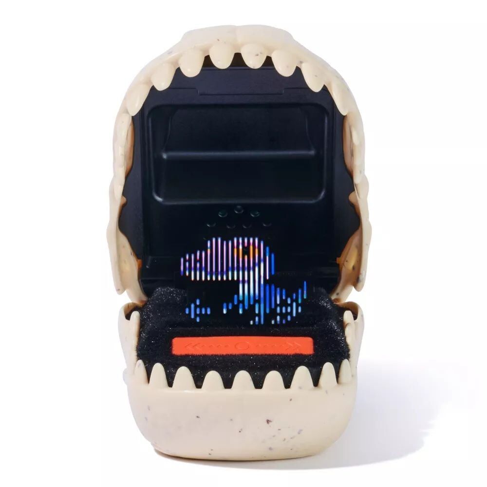 Open dinosaur skull-shaped handheld game with a glowing blue pixelated dinosaur on its screen and orange control buttons