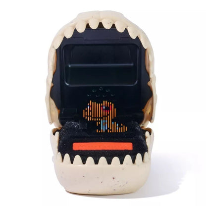 Open beige dinosaur skull toy reveals a retro digital pet game with a pixelated T-Rex on screen and an orange control button