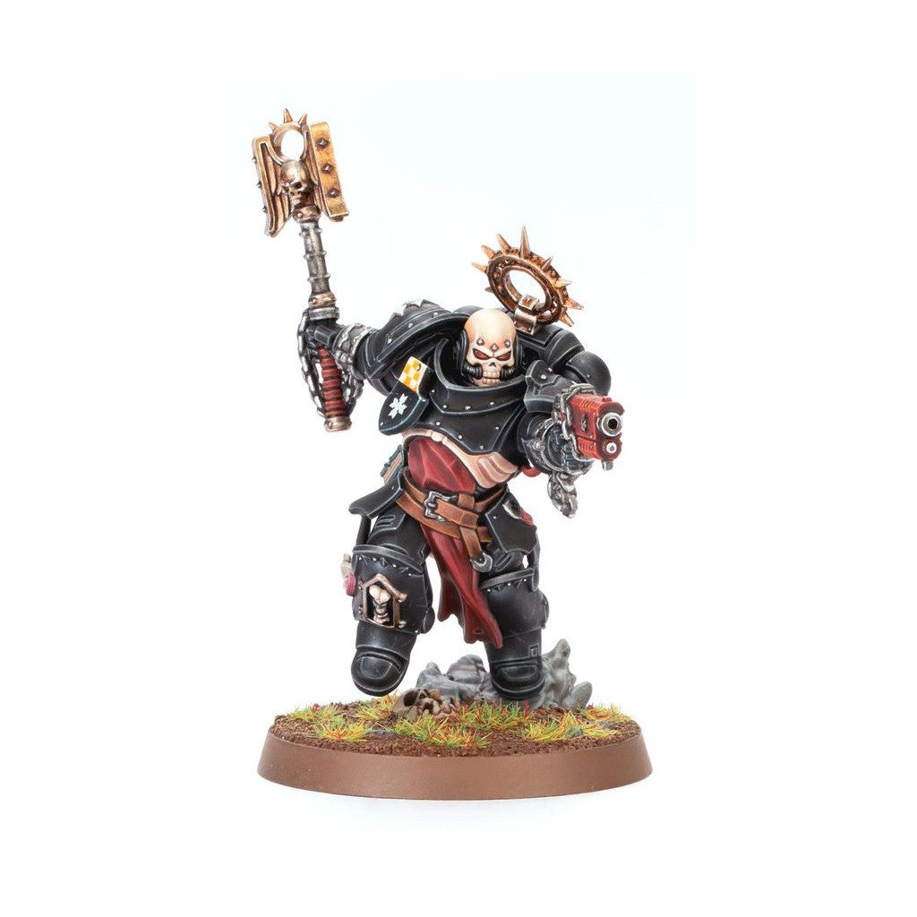 Black armored miniature warrior with a skull face, holding a golden hammer and a red pistol, a spiked halo is behind its head, standing on a grassy base
